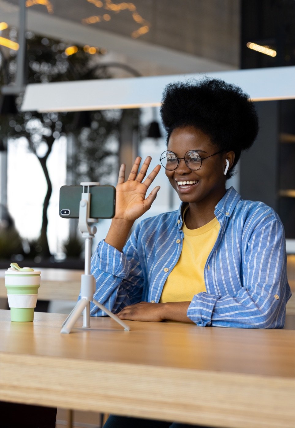 A participant waving at her phone during an interview